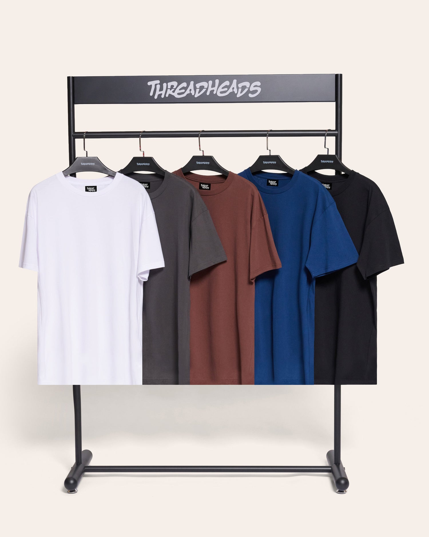Rack of blank and plain t-shirts in black, white, charcoal, navy and brown